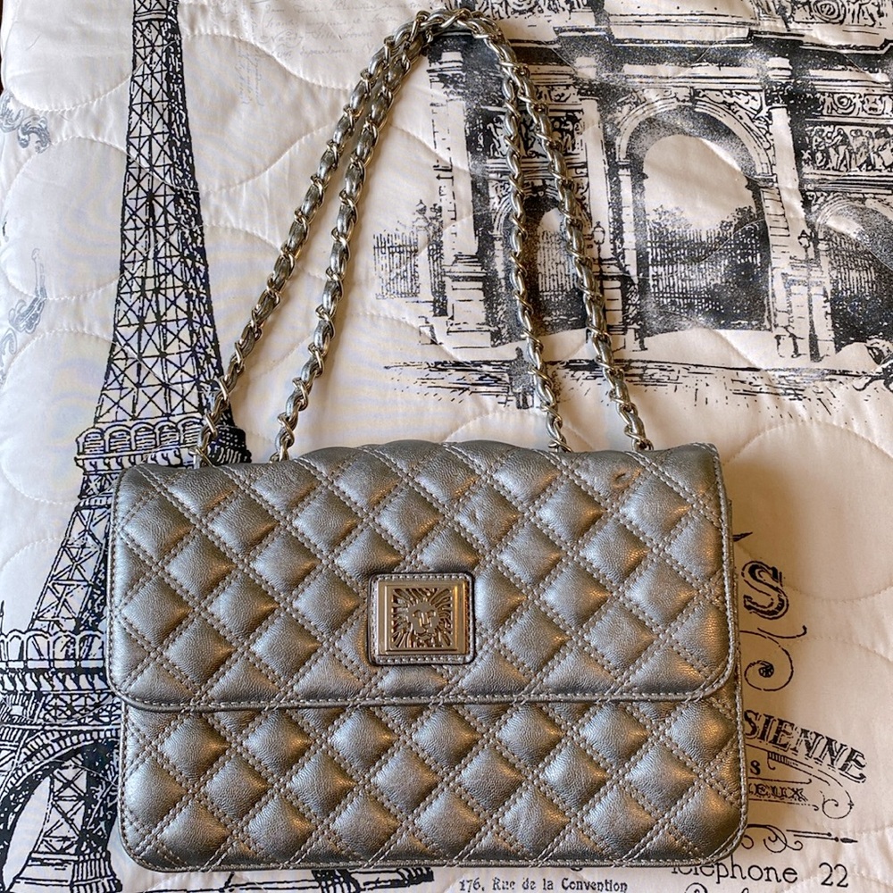 Metallic silver chain handbag quilted design. Like new with zebra print lining.